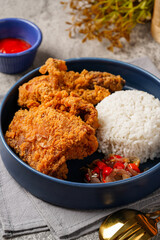 Ayam Geprek is an Indonesian Food crispy fried chicken with hot and spicy sambal Chili Sauce.