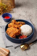 Ayam Geprek is an Indonesian Food crispy fried chicken with hot and spicy sambal Chili Sauce.