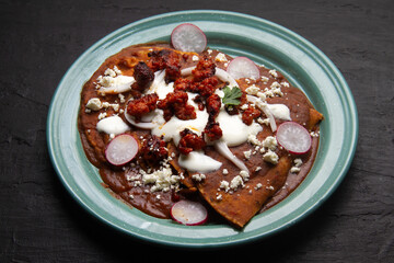 Mexican enfrijoladas with chorizo and fresh cheese