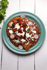 Mexican enfrijoladas with chorizo and fresh cheese