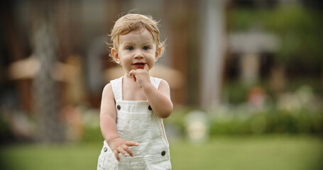 Naklejka premium little lovely boy walk in the park. Portrait of cute little blondie baby, blue eyes boy. Copy space
