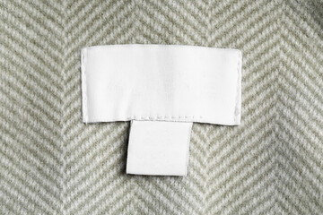 Clothing label on striped garment, top view