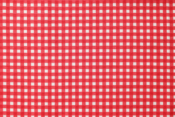 Red checkered tablecloth as background, top view