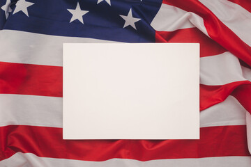 A blank white paper over the American flag