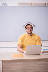 Young male student in telestudying concept