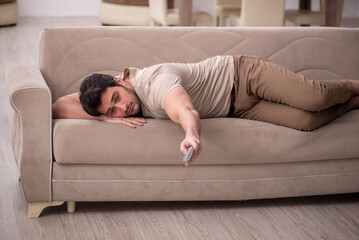 Young man watching tv at home