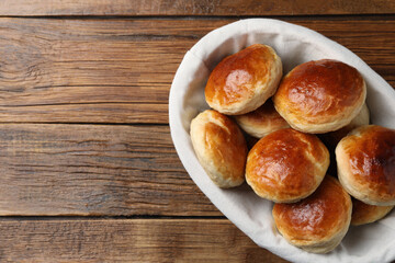 Tasty scones prepared on soda water on wooden table, top view. Space for text