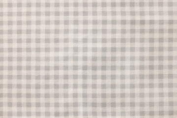 Beige checkered tablecloth as background, top view