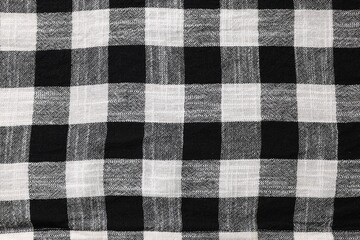 Black checkered tablecloth as background, top view