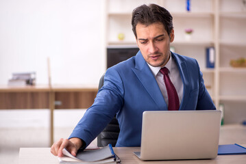 Young male employee and too much work in the office