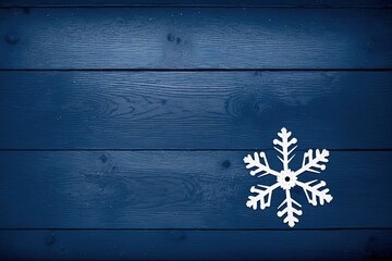 Fototapeta premium paper snowflake figure on blue color wooden background