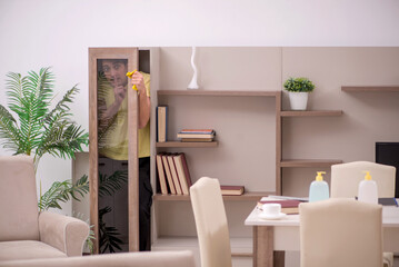 Young man doing housework indoors