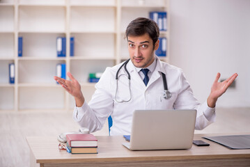 Young male doctor in telemedicine concept