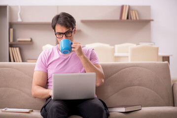 Young male student preparing for exams at home