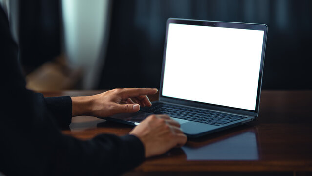 Man using laptop with white blank screen mockup