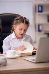 Small girl sitting in the classroom