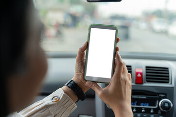 Happy couple using showing smartphone with empty screen, using mobile phone to look through navigation map during car trip