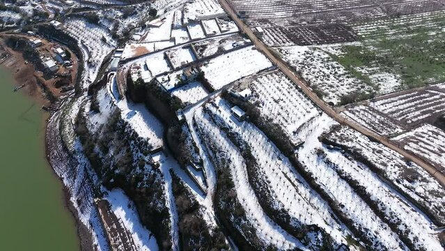 Drone view of Agriculture terrace fields covered with fresh white snow