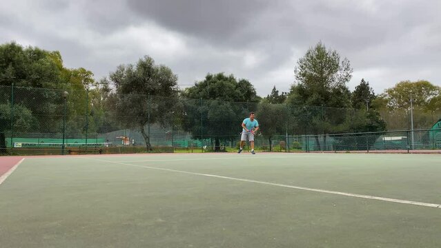 Sportive man Playing Professional Tennis On The Tennis Court , Sunny Day