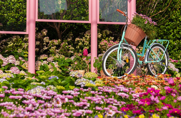 Fototapeta na wymiar bicycle in flower lane. street or garden decoration idea