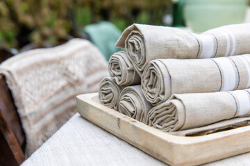 vue sur une pile de serviette empilées dans une assiette en bois sur une table à l'extérieur