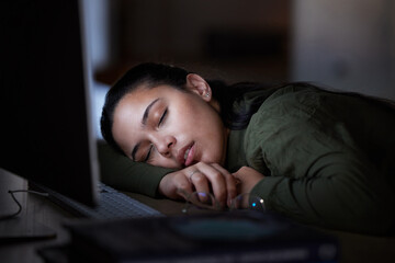 Tired, night and a business woman sleeping at her desk while working overtime in her office. Burnout, deadline and exhausted with a female employee asleep in the workplace during the late shift