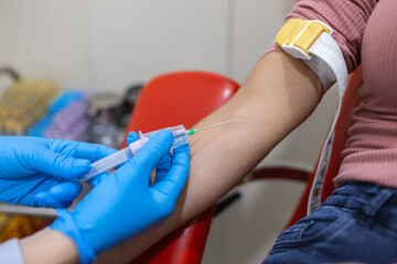 Preparation for blood test with pretty young woman by female doctor medical uniform on the table in...