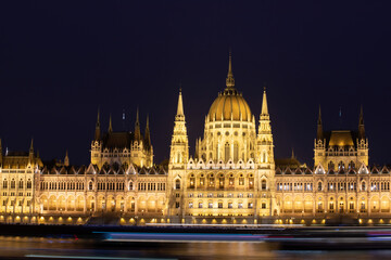 Budapest parliament illuminated at night and Danube river, Hungary