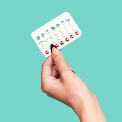 Woman hands, tablets and medication for birth control on mockup against a studio background. Hand of female holding contraception, healthcare product or medical prescription for market advertising