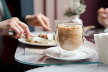 Cup of aromatic coffee standing on breakfast table. Enjoying life's simple pleasures
