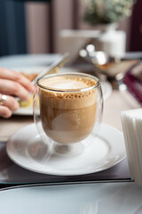 Cappuccino in a double Wall thermal glass. Morning breakfast with coffee