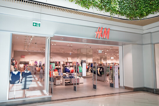 16 September 2022, Antalya, Turkiye: H and M casual mass market store and people passing by with bags with clothes. Shopping and leisure