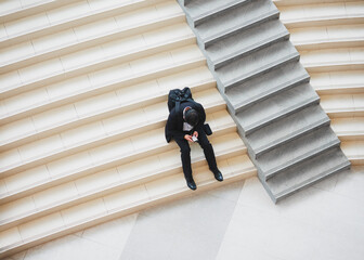 Business man chat on phone sitting on stairs indoor building office work City People Lifestyle