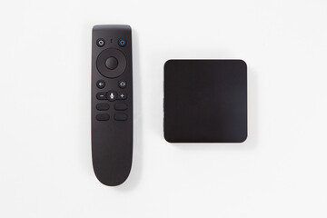black multimedia TV box and remote controller