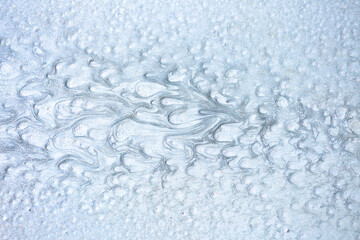 Texture of paint stains on the wall, cracked paint on an old metal surface. Sheet of silver metal with cracked and peeling paint, background for design with copy space.