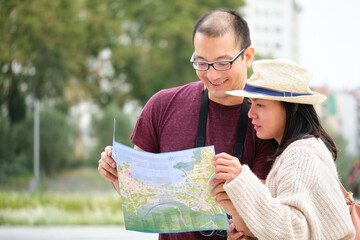 Multiracial couple of tourists consulting a city map. Sightseeing in Madrid, Spain.