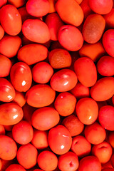 Beet flavored olives. Close-up pile of red kalamata olives