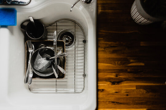 Overhead view of utensils in kitchen sink at home