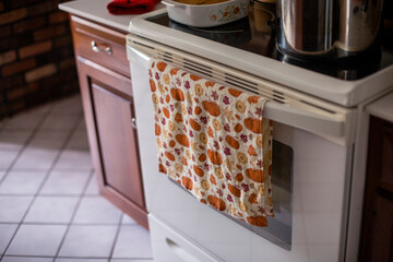 Close-up of dish towel against oven in kitchen at home