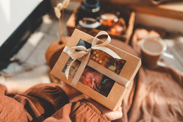 Box with macaroons in hands, festive packaging