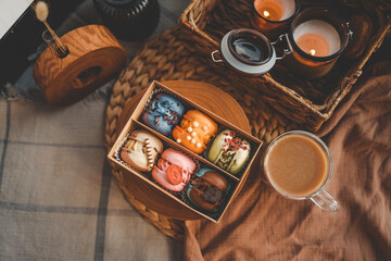 Box of macaroons with different assortment and a cup of coffee top view in a homely atmosphere