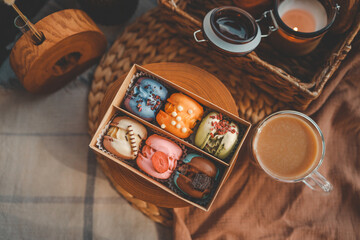 Box of macaroons with different assortment and a cup of coffee top view in a homely atmosphere