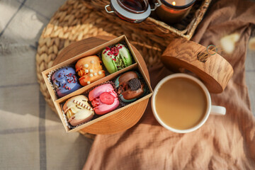 Box of macaroons with different assortment and a cup of coffee top view in a homely atmosphere