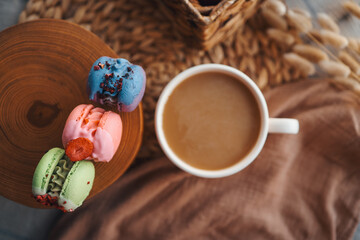 Box of macaroons with different assortment and a cup of coffee top view in a homely atmosphere