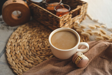 Cup of coffee and macarons in a cozy home interior, the concept of a good morning