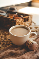 Cup of coffee and macarons in a cozy home interior, the concept of a good morning