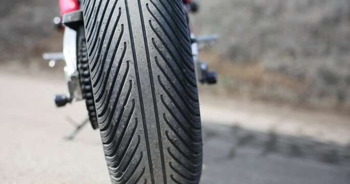 Tread on black tire on motorcycle wheel closeup 4k movie slow motion