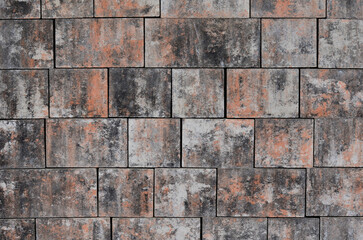 Fototapeta premium cement concrete pavement with irregular spots of gray color. two sizes of tiles per square. cheap texture regard lolmo down from the drone, brown, sabdstone, brick