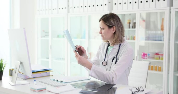 Doctor therapist looking at xray of lungs in clinic 4k movie slow motion