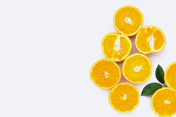 Orange fruit with green leaves on white background.
